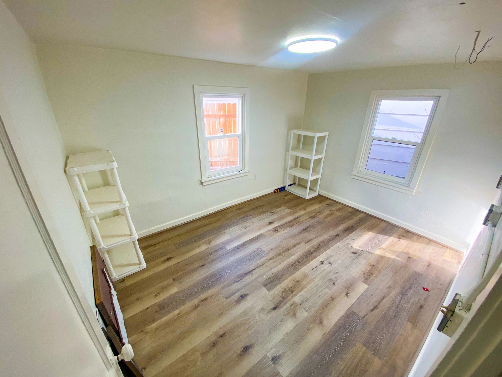 Fresh flooring and clean interior finish in renovated room